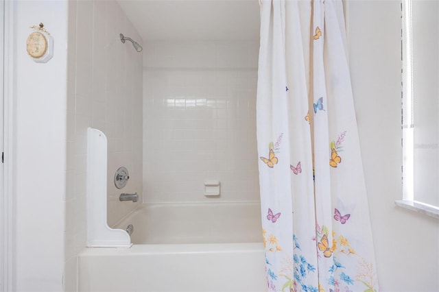 bathroom with shower / bath combo with shower curtain