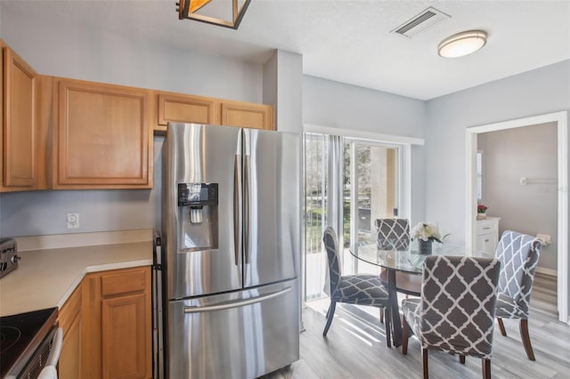 kitchen featuring stainless steel appliances and light wood-type flooring