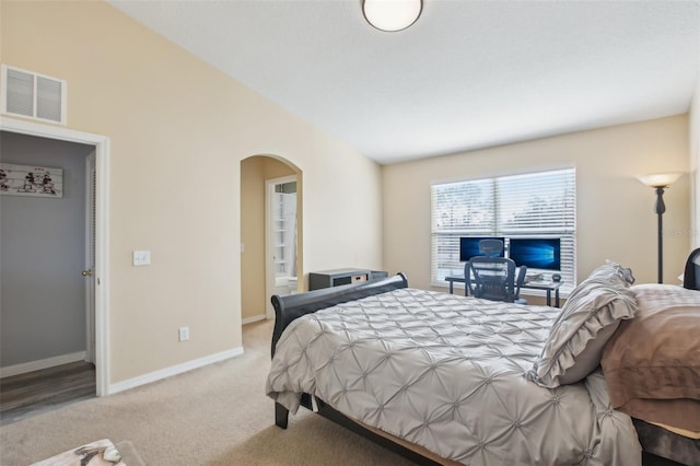 carpeted bedroom with vaulted ceiling