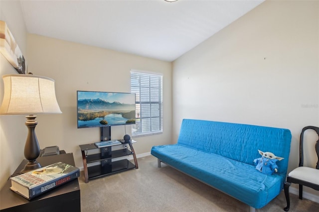 sitting room featuring carpet and lofted ceiling