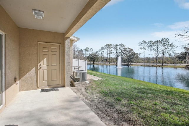 view of yard with a water view and central air condition unit