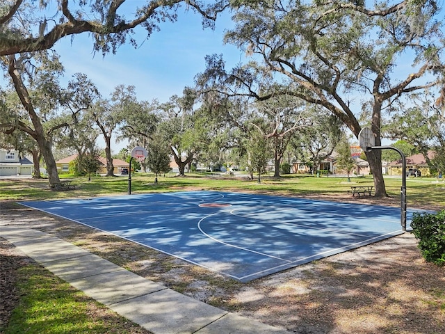 view of basketball court with a lawn