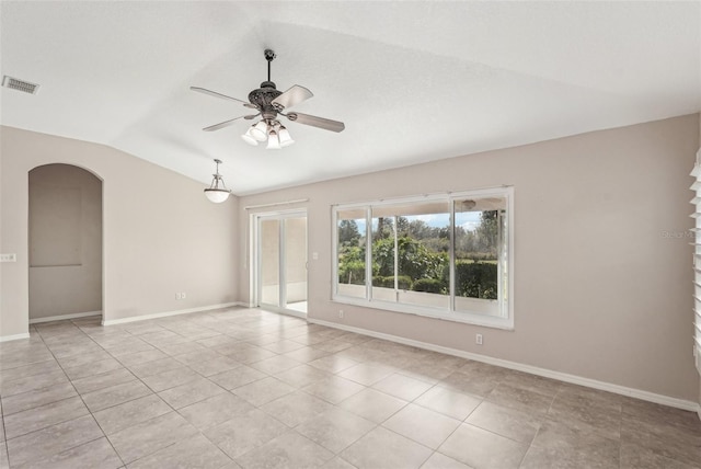 tiled empty room with lofted ceiling and ceiling fan