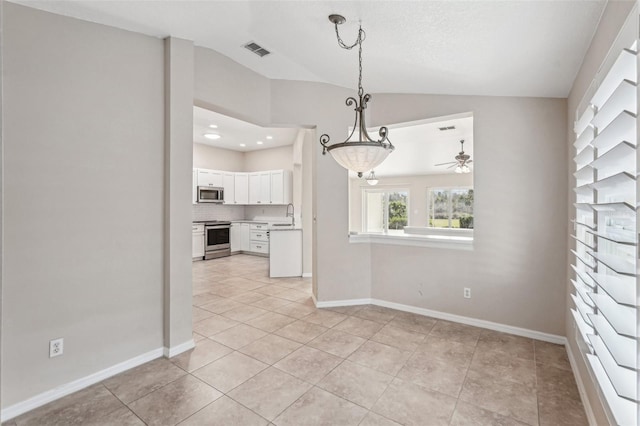 interior space featuring light tile patterned flooring, lofted ceiling, sink, and ceiling fan