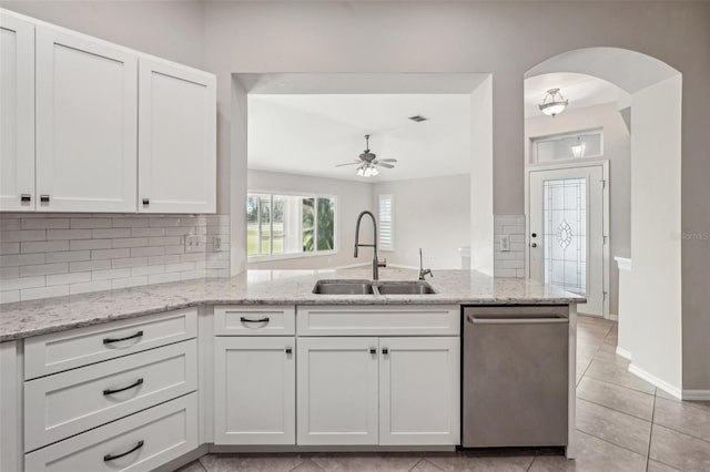 kitchen with white cabinetry, dishwasher, sink, and light stone countertops