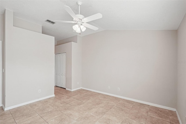 spare room with vaulted ceiling and ceiling fan