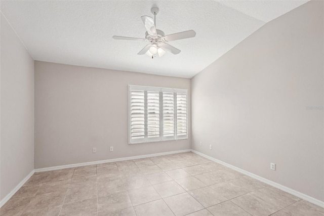 empty room featuring lofted ceiling, a textured ceiling, and ceiling fan