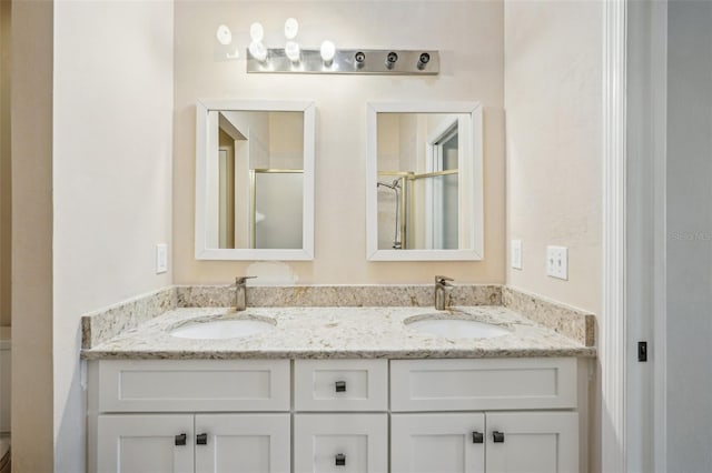 bathroom featuring vanity and an enclosed shower