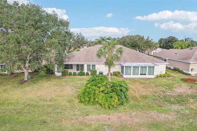 rear view of house featuring a lawn