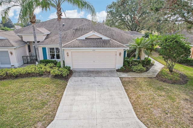 view of front of house with a garage and a front lawn