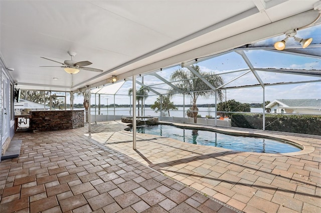 view of swimming pool featuring a water view, a lanai, an outdoor bar, and a patio