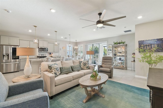 tiled living room featuring ceiling fan