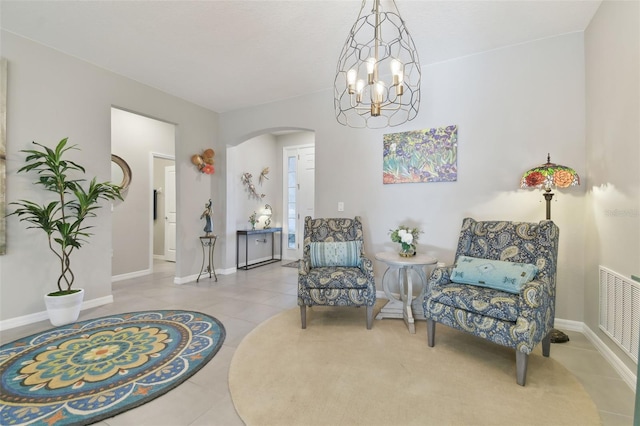 living area featuring tile patterned flooring and a chandelier