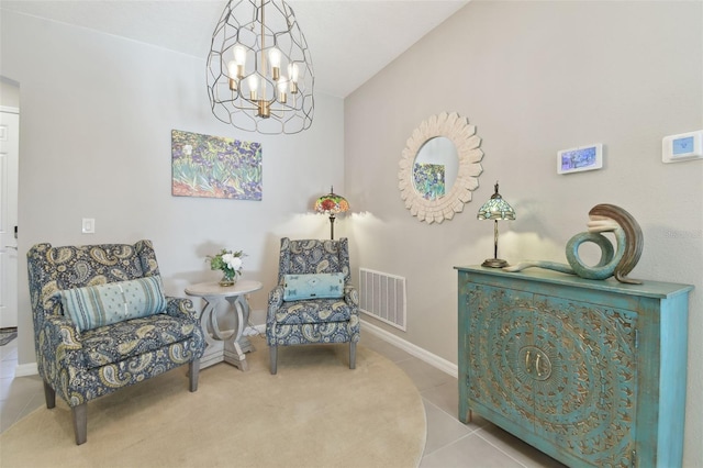 sitting room with lofted ceiling, tile patterned floors, and a notable chandelier