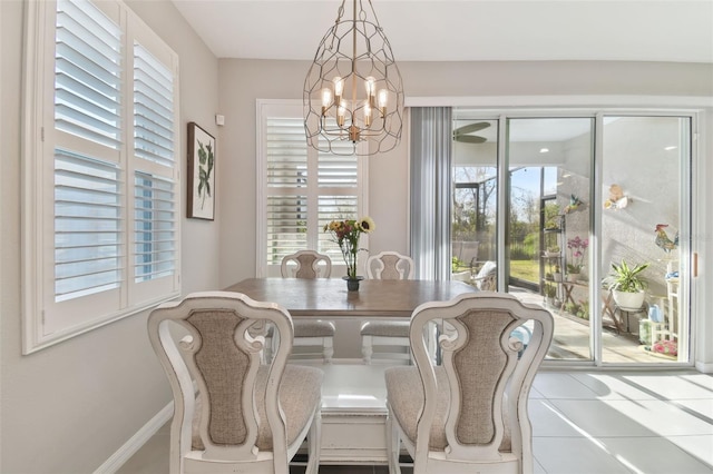 dining area featuring light tile patterned floors and a chandelier