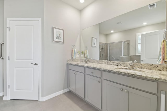 bathroom featuring tile patterned flooring, vanity, and walk in shower