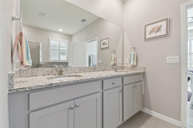 bathroom with vanity, a shower with door, and tile patterned floors