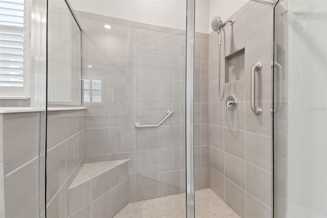 bathroom with a shower with shower door