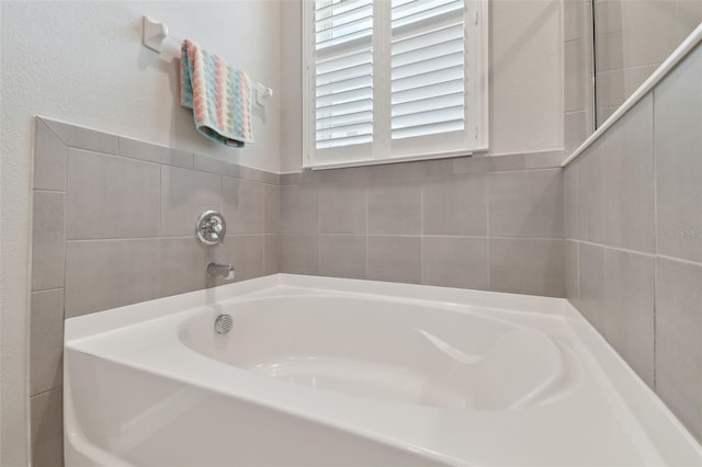 bathroom with a tub to relax in