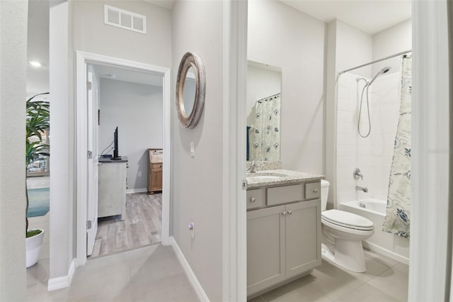 full bathroom featuring vanity, tile patterned floors, toilet, and shower / bath combo