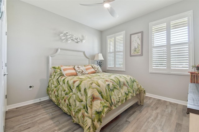 bedroom with wood-type flooring and ceiling fan