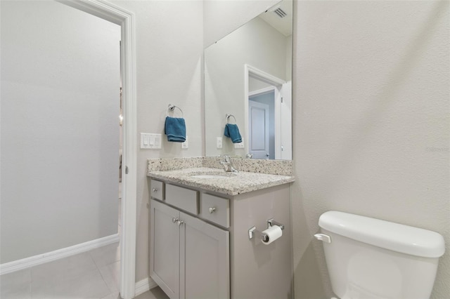 bathroom with vanity, tile patterned flooring, and toilet