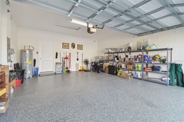 garage with water heater and a garage door opener