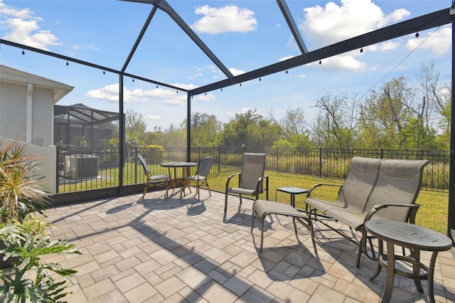 view of patio / terrace featuring glass enclosure and central air condition unit