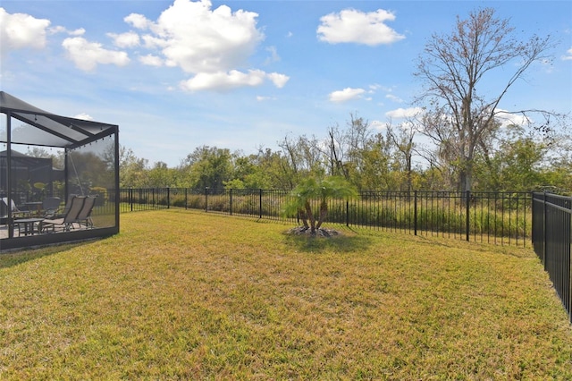 view of yard featuring glass enclosure