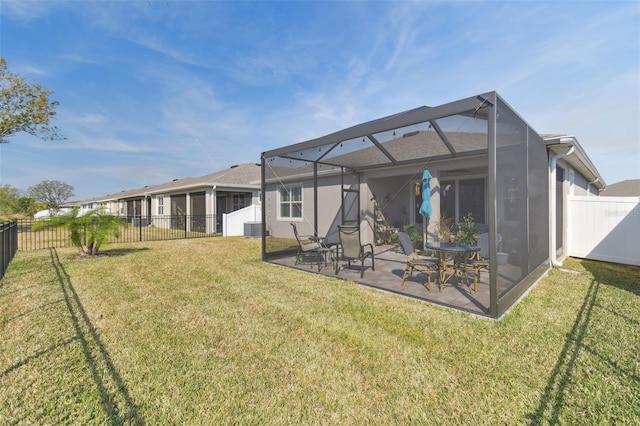 back of house with a lanai, a patio area, a lawn, and central air condition unit