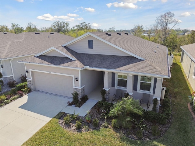 view of front of property with a garage and a front yard