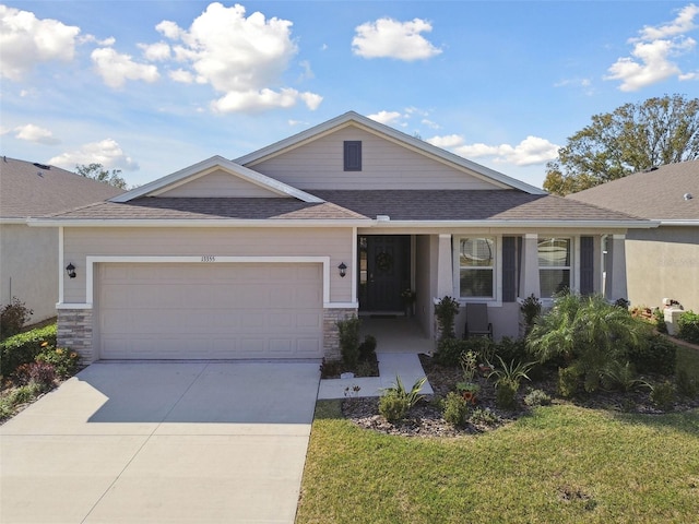 view of front of property featuring a garage and a front yard