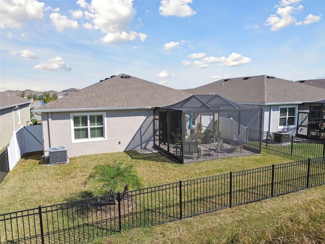 rear view of house featuring a patio, a lanai, cooling unit, and a lawn