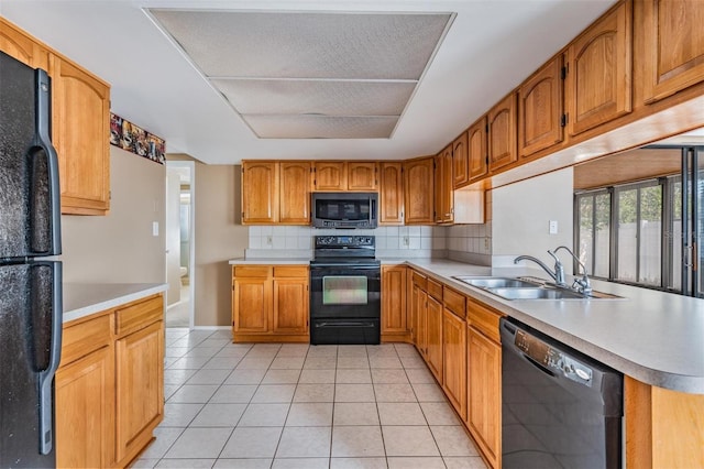 kitchen featuring sink, light tile patterned floors, black appliances, decorative backsplash, and kitchen peninsula