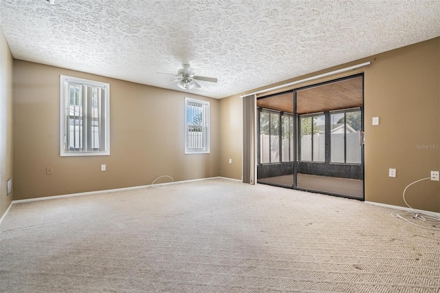 unfurnished room with ceiling fan, carpet floors, and a textured ceiling