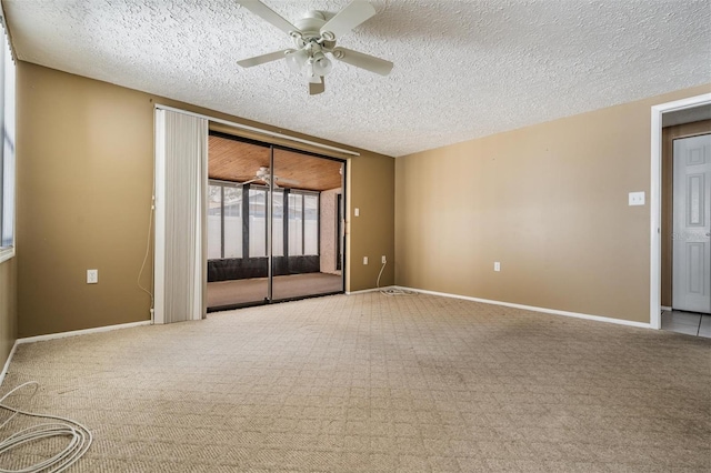 spare room featuring ceiling fan, light carpet, and a textured ceiling