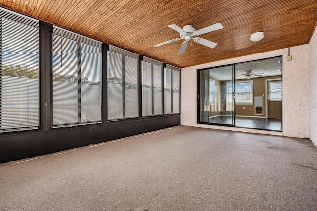 unfurnished sunroom featuring ceiling fan and wood ceiling