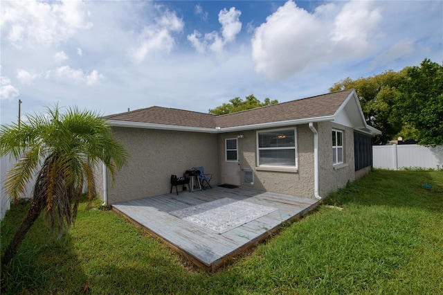 rear view of property with a lawn and a patio