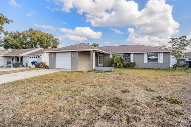 ranch-style home with a garage and a front lawn