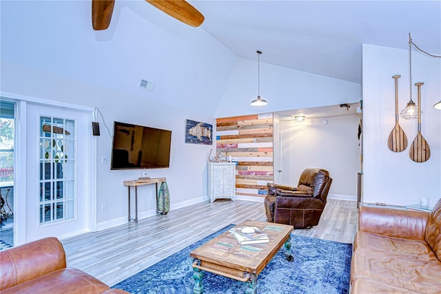 living room with ceiling fan, high vaulted ceiling, and hardwood / wood-style floors