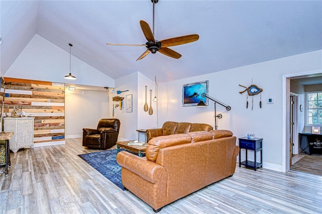 living room with hardwood / wood-style flooring, vaulted ceiling, and ceiling fan