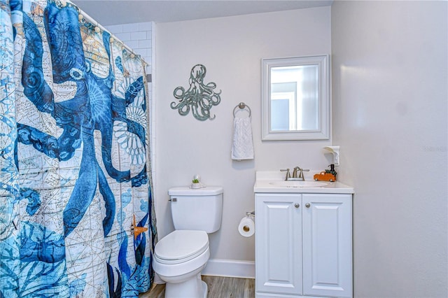 bathroom with vanity, wood-type flooring, a shower with shower curtain, and toilet