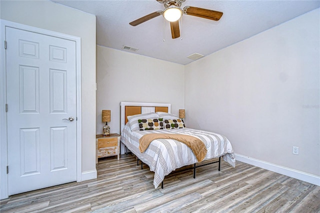 bedroom featuring light hardwood / wood-style flooring and ceiling fan