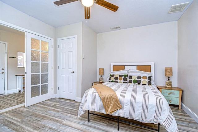 bedroom featuring ceiling fan and light hardwood / wood-style flooring