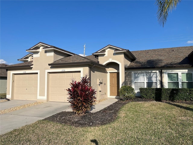 ranch-style home with a garage and a front lawn