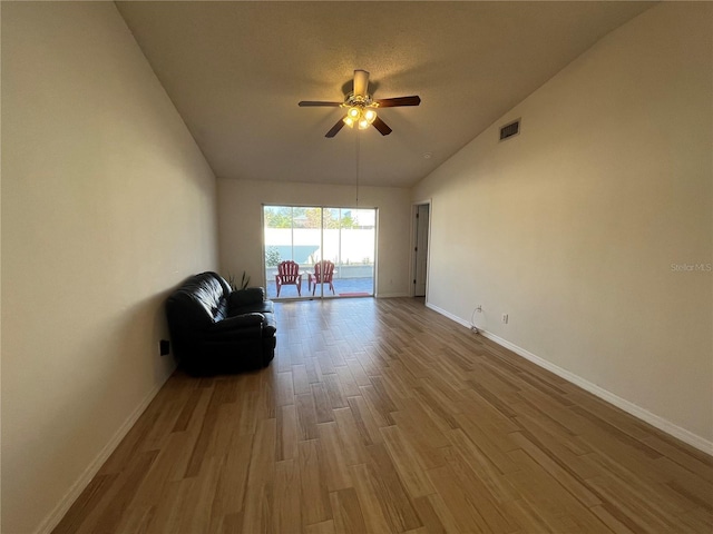 unfurnished room with ceiling fan, high vaulted ceiling, and light hardwood / wood-style flooring