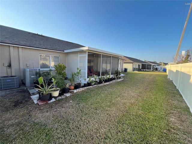 view of yard featuring central AC and a sunroom