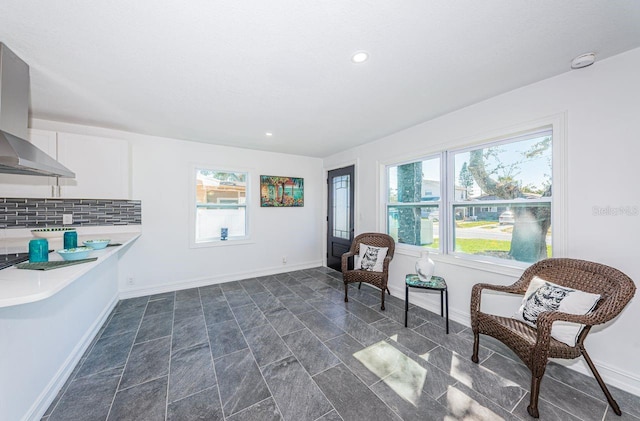 living area with baseboards and recessed lighting