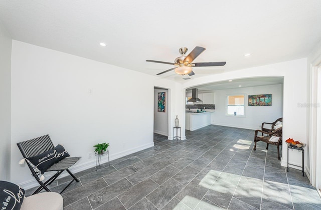 living area featuring ceiling fan, recessed lighting, and baseboards