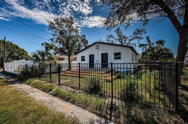 view of home's exterior featuring a fenced front yard and stucco siding